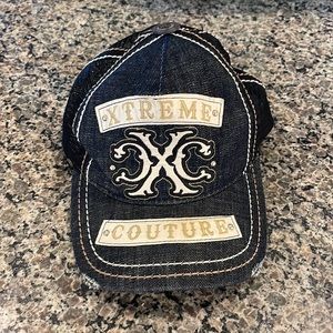 XTREME COUTURE BLACK ADJUSTABLE TRUCKER HAT